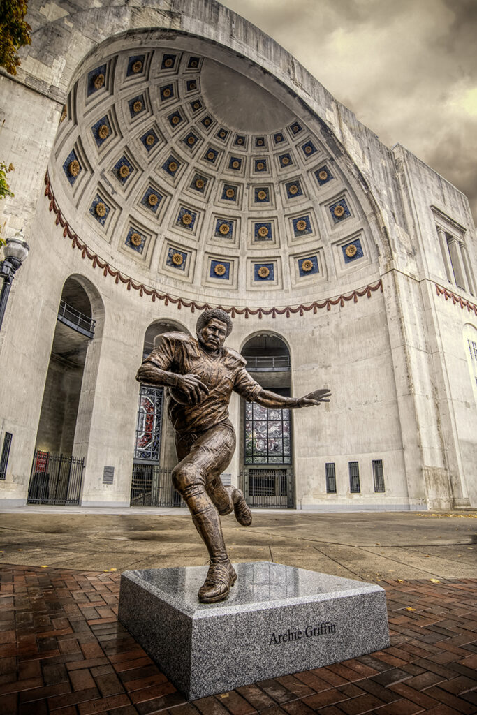Archie Griffin statue photographed with a wide-angle lens in front of the entrance to Ohio Stadium